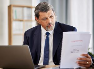 Attorney reviewing documents for asset recovery and levy execution.